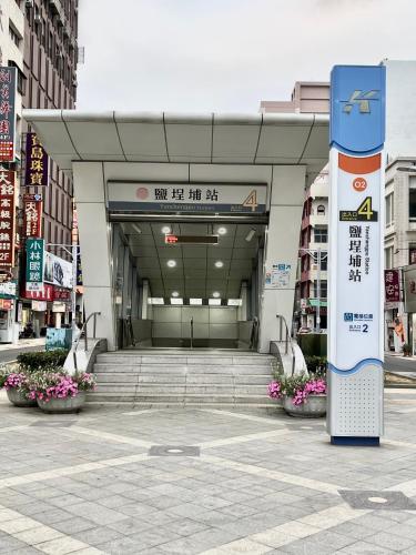 an entrance to a building with stairs and flowers at Sa-Yo Hotel - Pier 2 in Kaohsiung