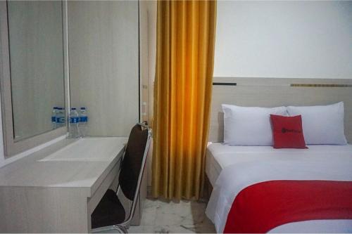 a hotel room with a bed and a sink at RedDoorz near Araya Family Club House in Malang