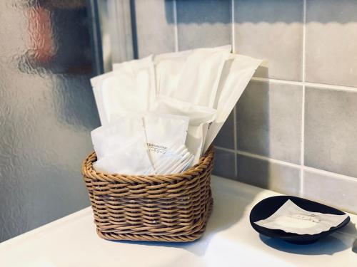 a basket of tissues sitting on a counter in a bathroom at 湯園民宿 l 民宿編號1639 in Taitung City