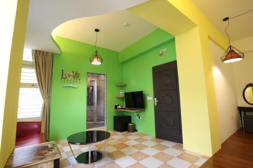 a living room with green walls and a black door at 湯園民宿 l 民宿編號1639 in Taitung City