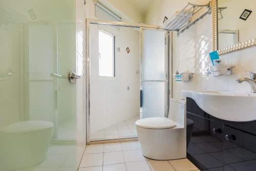 a bathroom with a sink toilet and a shower at 湯園民宿 l 民宿編號1639 in Taitung City