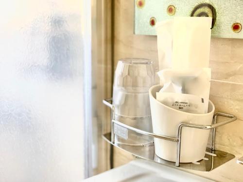 a kitchen counter with a shelf with paper towels at 湯園民宿 l 民宿編號1639 in Taitung City