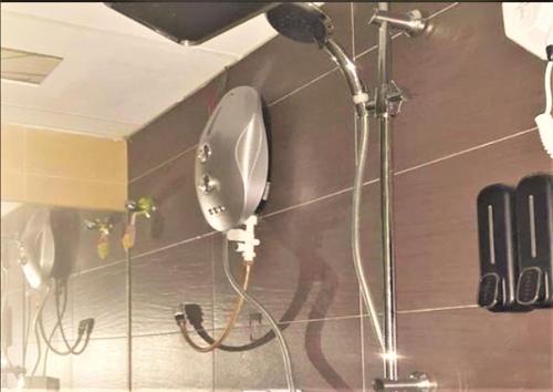 a shower in a bathroom with a blow dryer at Vibe Hotel in Kuala Lumpur