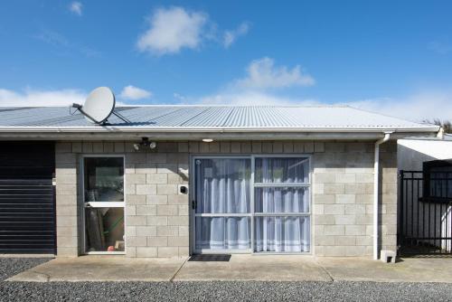 a house with a window and a satellite at Nine Acres in Invercargill
