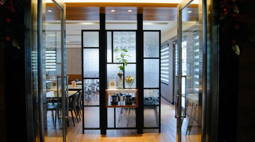 a dining room with a table and a glass wall at Kuei Ti Wan Hotel in Checheng