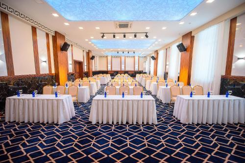 a row of tables and chairs in a banquet hall at Kazakhstan Hotel in Almaty