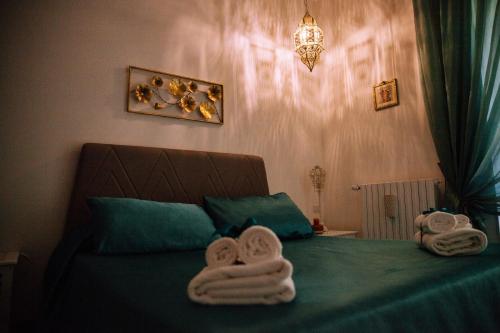 a bedroom with a bed with towels on it at AleAndre in Foggia