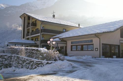 a building with snow in front of it at Hotel Miage in Aosta