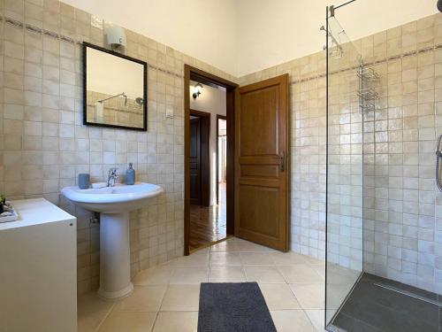 a bathroom with a sink and a glass shower at Villa Berenice in Butkovići