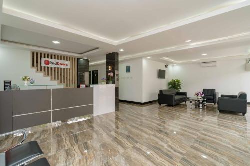 a lobby with a waiting room with chairs and a reception desk at RedDoorz Plus near Eka Hospital BSD 5 in Tangerang