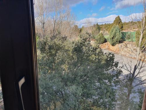a view of a tree from a train window at HOTEL MASIA EL MOLINETE in Mora de Rubielos