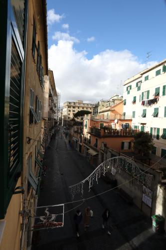 a group of people walking down a street at Le case di Elisa 3 in Genova