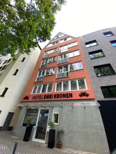 a building with a hotel dial roman sign on it at Hotel Drei Kronen in Cologne
