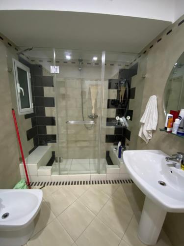 a bathroom with a shower and a sink and a toilet at Villa Panorama - 3 Bedrooms Sea View - Free Parking in Sarandë