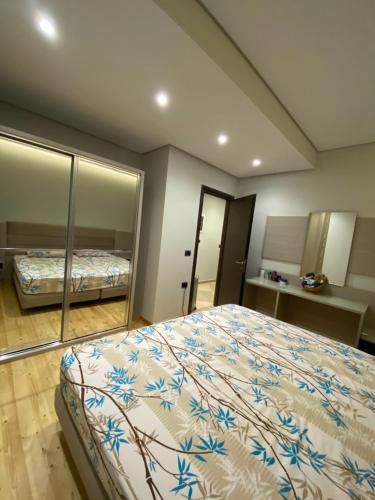 a bedroom with a large bed with mirrored walls at Villa Panorama - 3 Bedrooms Sea View - Free Parking in Sarandë