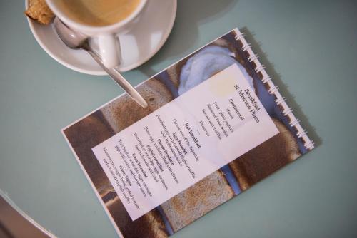 a book sitting on a table with a cup of coffee at Melrose Place Guestrooms in Potchefstroom