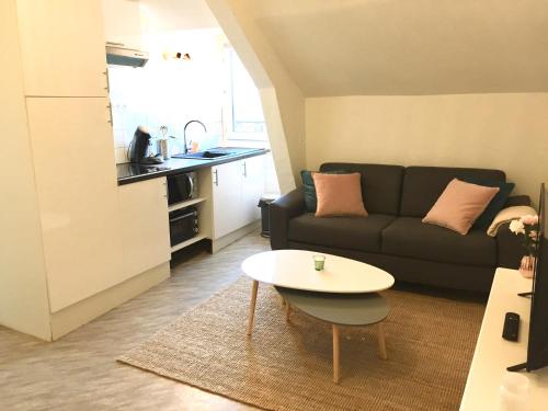 un salon avec un canapé et une table dans l'établissement Appartement bord de mer centre-ville, proche gare, au Pouliguen