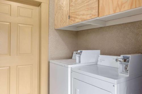 a laundry room with a white washer and dryer at Super 8 by Wyndham Crestview in Crestview