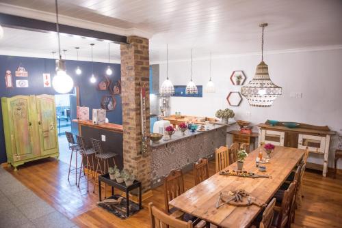 a dining room and kitchen with a table and chairs at Melrose Place Guestrooms in Potchefstroom