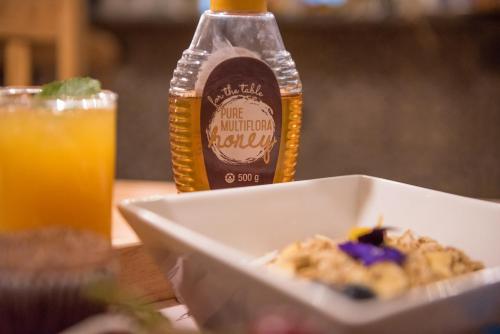 a bowl of food and a bottle of ketchup at Melrose Place Guestrooms in Potchefstroom