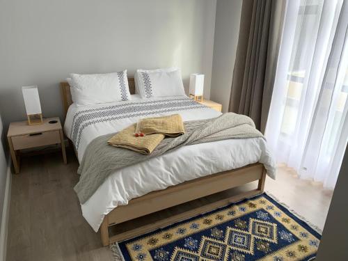 a bedroom with a bed with two towels on it at Romansbaai at 402 - with solar power in Gansbaai