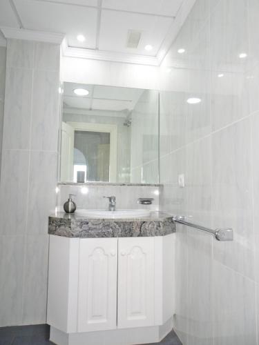 a bathroom with a sink and a mirror at GOLF Y MAR - Oliva Nova in Oliva