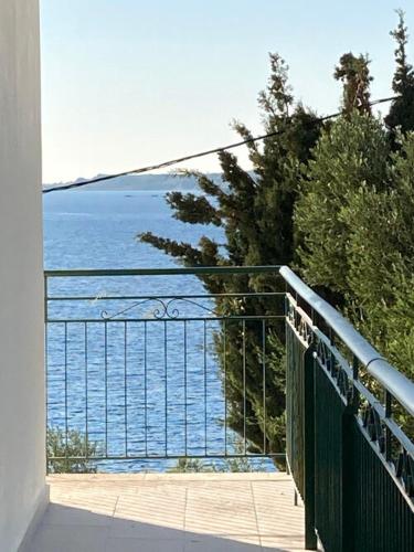 a view of the ocean from the balcony of a house at Studios Angeliki in Lassi
