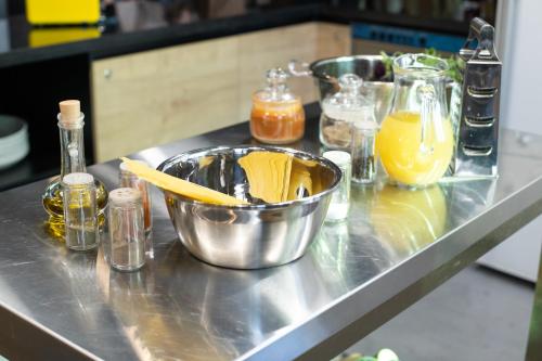 a kitchen counter with a bowl of pasta and other ingredients at Kantar Hostel in Yerevan