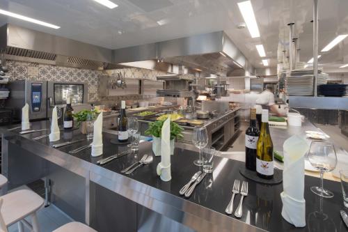 a kitchen with a counter with wine bottles and glasses at Buchnas Landhotel Saarschleife in Mettlach