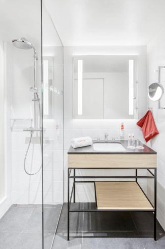 a bathroom with a sink and a shower at IntercityHotel Budapest in Budapest