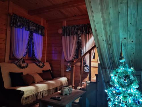 a living room with a christmas tree in a room at BRVNARE STOJIĆ in Kokin Brod