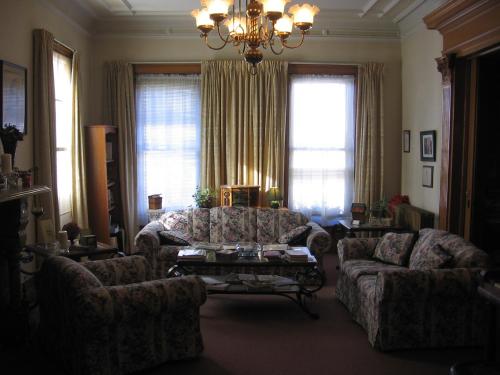 a living room with two couches and a coffee table at Olde Judge Mansion B&B in Troy