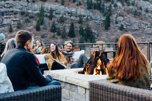 a group of people sitting around a fire pit at Imogene Hotel in Ouray