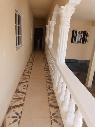 a staircase in a house with white columns at Grace Garden Guesthouse by Eminence Ent in Ocho Rios
