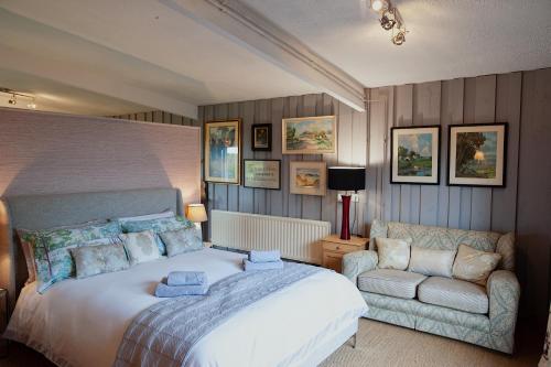 a bedroom with a large bed and a couch at The Cabin - Luxury Country Living in Cullybackey