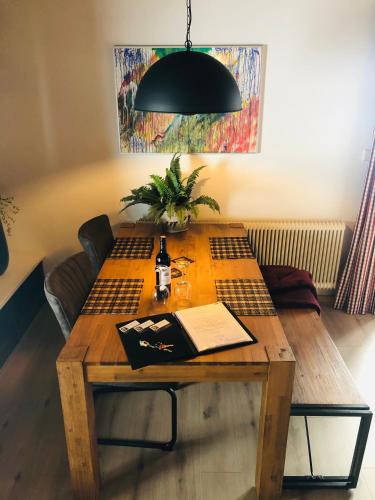 a wooden table with a book on top of it at Schans Appartements in Hermagor