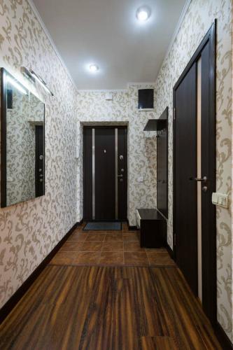 an empty hallway with a door and a wooden floor at Nadezhda Apartments in Keremet on Timiryazev street 1 in Almaty