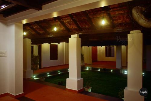Cette chambre avec piscine est située dans un bâtiment doté d'un plafond. dans l'établissement Kayyalas Courtyard, à Thrissur