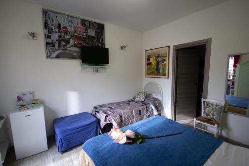 a room with two beds and a tv on the wall at For Ever Apartments in Fiumicino
