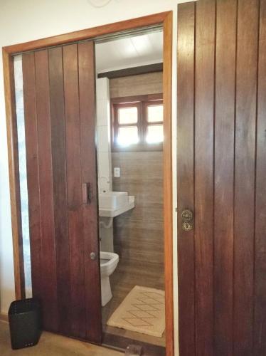 a bathroom with a toilet and a sink at Vila Bello Pontal in Coruripe