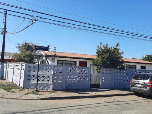 a blue fence in front of a house at casa completa Balmaceda 77 in Concepción