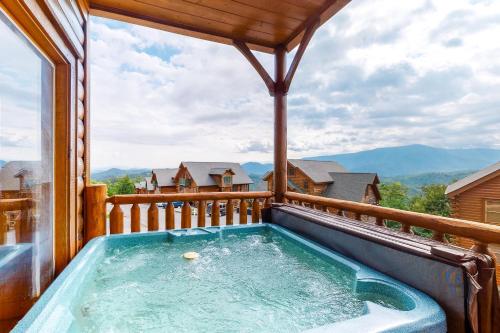 a hot tub on the balcony of a log cabin at Big Sky in Pigeon Forge
