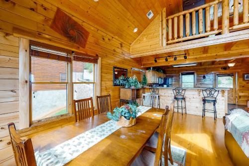 a dining room with a wooden table in a cabin at Big Sky in Pigeon Forge