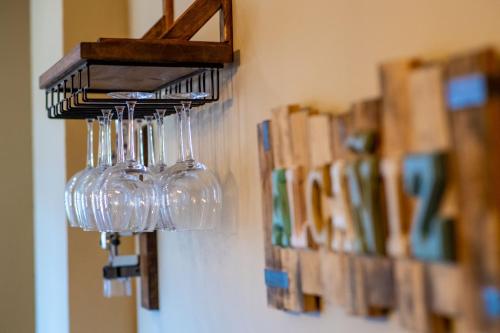 a group of wine glasses hanging from a wall at MEQUEDO CASA PILARCHO in Alcañiz
