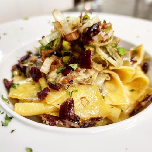 a bowl of pasta with bacon and other ingredients at Hotel Ristorante Morus in Burago di Molgora