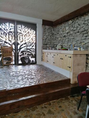 a room with a large window with a stone wall at Wineyards Salin in Turda