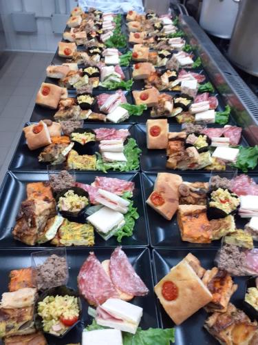 a row of plates filled with different types of food at Hotel Ristorante Morus in Burago di Molgora