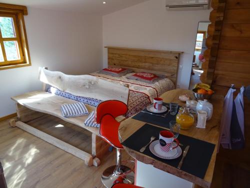 a bedroom with a bed and a table with cups and dishes at Domaine des hauts de Vernon in Vernon