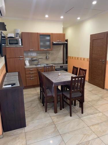 a kitchen with a table and chairs in a room at Villa Gracia Podhájska in Podhájska