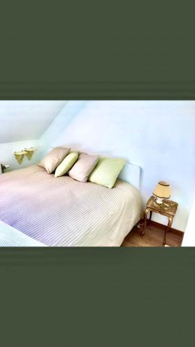 a bedroom with a bed with three pillows on it at Foodiejive in Antwerp